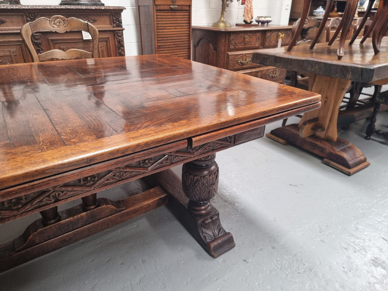 Renaissance style Oak extension table with parquetry top and twin pedestal base. The table extends by pulling out an extension leaf either side making it 287 cm long. Sourced from France and in good original detailed condition.