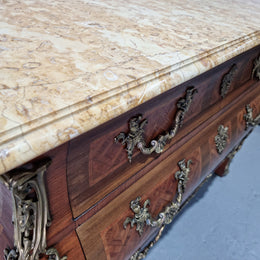 A beautifully inlaid parquetry three drawer commode with a lovely marble top, and decorative ormolu mounts. In good original detailed condition. Circa 1930