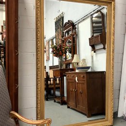 Very large French style mirror with beveled glass. In very good original condition.