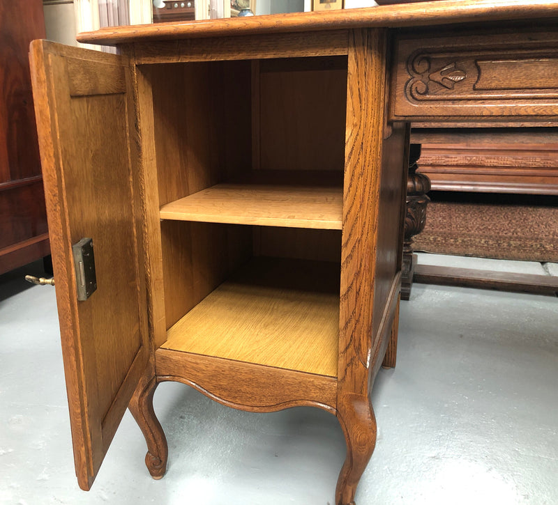 Beautifully carved French oak small desk with three drawers and a cupboard for all your storage needs. In good original condition. Great size for small spaces.