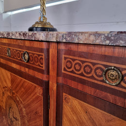 A high quality 19th Century French marquetry inlaid Kingwood marble top credenza. It has an attractive solid marble top and decorative marquetry inlay throughout. It has plenty of storage space with three drawers and three doors. It has been sourced from France and is in good original detailed condition.