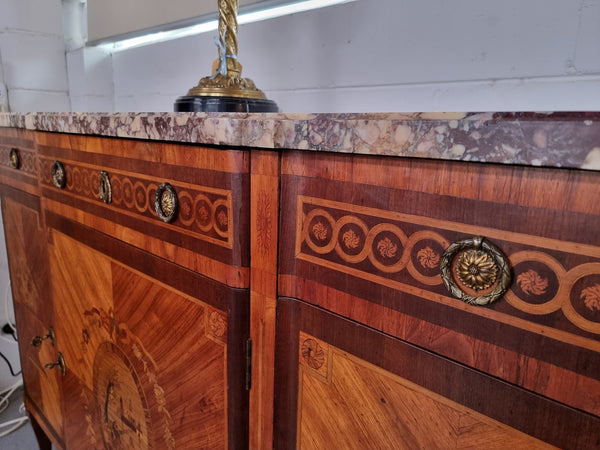 A high quality 19th Century French marquetry inlaid Kingwood marble top credenza. It has an attractive solid marble top and decorative marquetry inlay throughout. It has plenty of storage space with three drawers and three doors. It has been sourced from France and is in good original detailed condition.