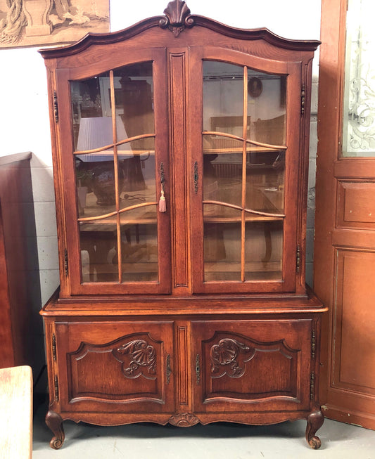 Vintage French Oak two door bookcase/display cabinet with a two door storage cabinet at the bottom. It is in good original condition.