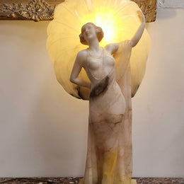 Monumental Art Deco alabaster and marble figural lamp modelled as a seductively dressed semi naked woman. In subtlety coloured diaphanous robes with a large clam shell light backdrop. Italian circa 1920's signed to base. This is a world class example of a true Art Deco sculpture lamp. It is in good original detailed condition, please view photos as they help form part of the description.