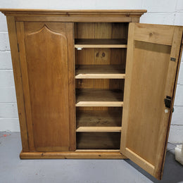 A lovely Victorian Pine shield cupboard with two doors and four shelves in good original detailed condition.