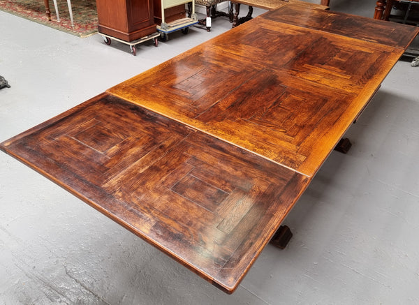 Renaissance style Oak extension table with parquetry top and twin pedestal base. The table extends by pulling out an extension leaf either side making it 287 cm long. Sourced from France and in good original detailed condition.
