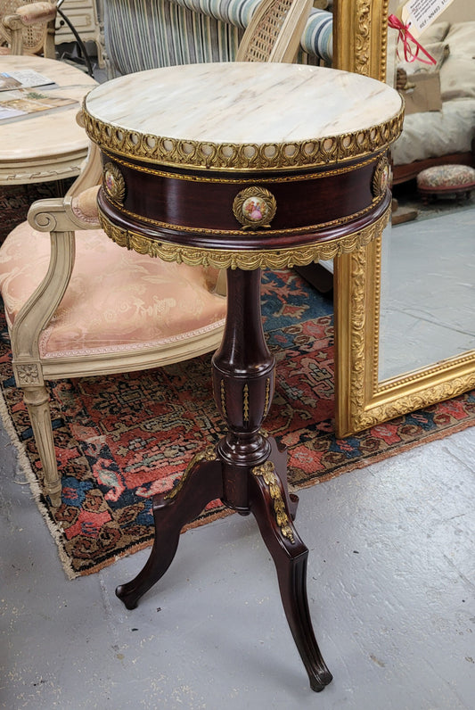 Elegant French louis XVI revival style round marble top side table with ceramic features and ormolu decoration. It is in good original detailed condition and has been sourced from France.