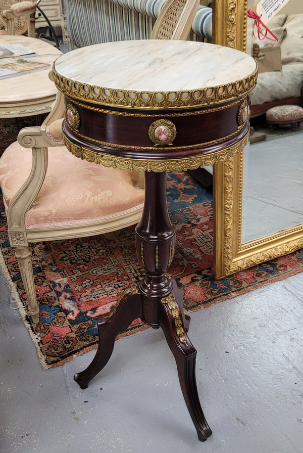 Elegant French louis XVI revival style round marble top side table with ceramic features and ormolu decoration. It is in good original detailed condition and has been sourced from France.