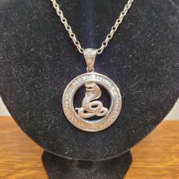 Sterling Silver pendant featuring a Cobra Snake with Cubic Zirconia surround. Heavy Bale with Cubic Zirconia. Pendant without Bale, 3.5cm Diameter. Includes 60 cm Sterling Silver Chain.