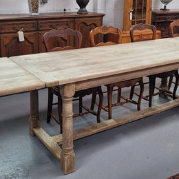 Beautilful raw solid oak French pedestal extension table. It has been sourced from France and is in good original detailed condition. When the table is fully extended it is 339 cm long and can comfortable seat 10-12 people. Features raw wood that could be used as is for a distressed look, or finished and waxed for a more refined look.