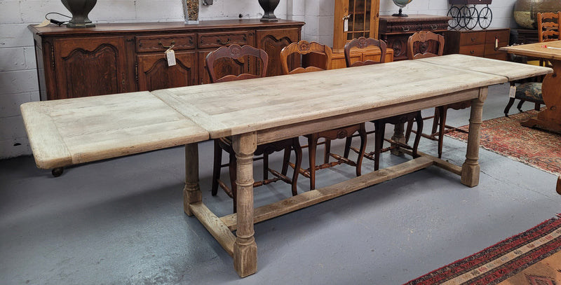 Beautilful raw solid oak French pedestal extension table. It has been sourced from France and is in good original detailed condition. When the table is fully extended it is 339 cm long and can comfortable seat 10-12 people. Features raw wood that could be used as is for a distressed look, or finished and waxed for a more refined look.