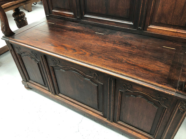 Beautifully carved French Oak hall seat with a lift up lid and storage space inside. In good original detailed condition.