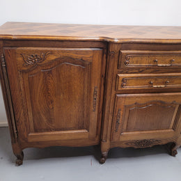 French Oak Louis XV style three door, two drawer, parquetry top sideboard. It has been sourced from France and is in good restored condition.