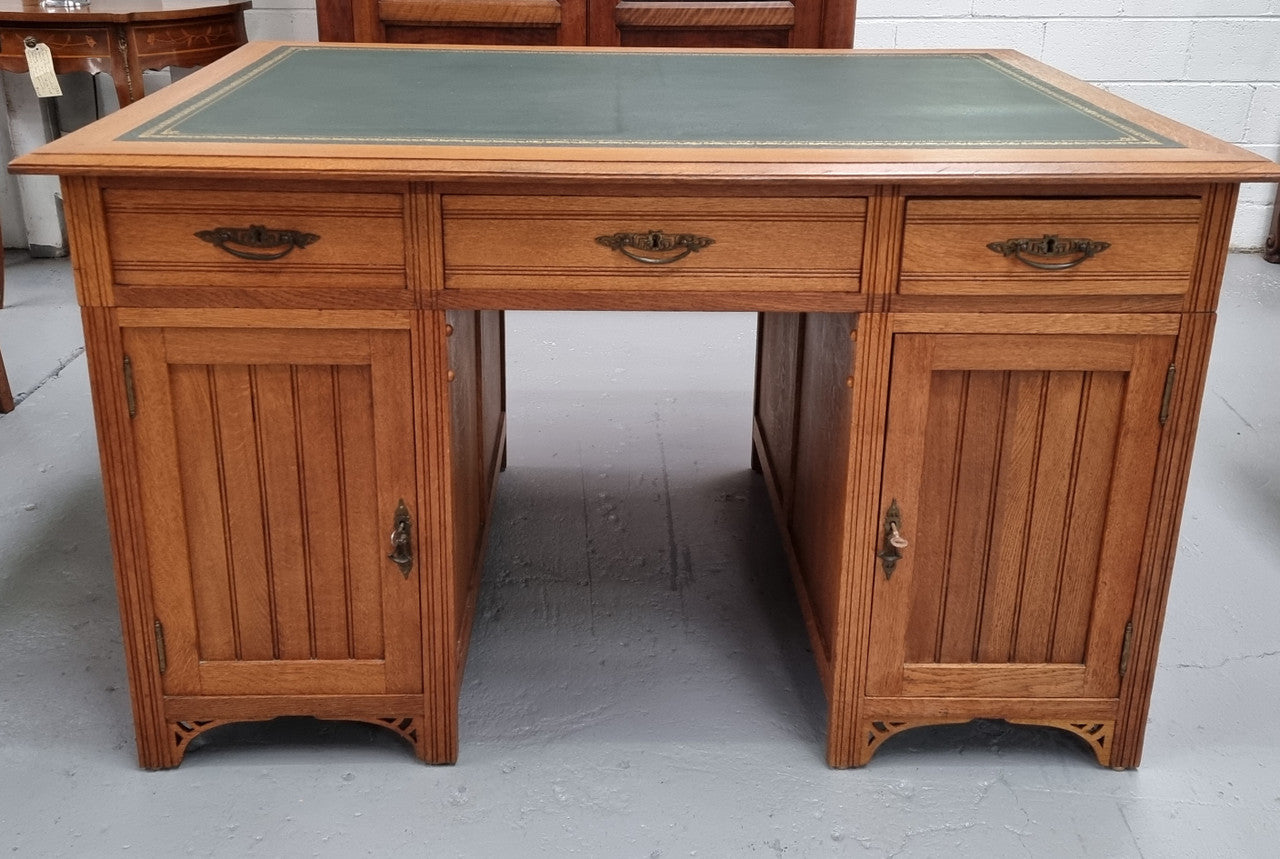 French Oak Art Deco full partners desk with leather top. Plenty of storage with both sides having three drawers at the top and two cupboards on both sides, one side has a filing section with three internal drawers and the other has a shelf on one side with three internal drawers as well. In good original detailed condition.