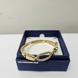 Swarovski gold toned fitted bangle set with Swarovski crystals. Swarovski mark to band, and a side opening. Charming little bracelet. Please see photos as they form part of the description.