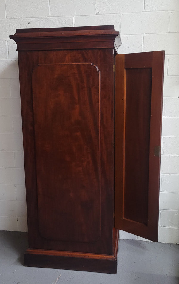 Unusual Victorian Flame Mahogany side wardrobe with side door. It has full hanging and six hooks. The wardrobe opens from a side door which can be locked with its key and has a markers mark stamp on the door. It is in good original condition.