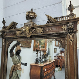 Early 19th Century French gilt and simulated wood mantel mirror. It still contains its original glass which contains loads of character. It is in very good detailed condition and has had minor restorations.