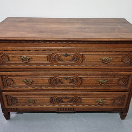 Early 19th Century French Oak chest of three drawers. It has beautiful handles and carvings. It is in good original detailed condition.