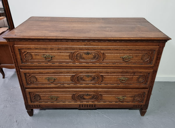 Early 19th Century French Oak chest of three drawers. It has beautiful handles and carvings. It is in good original detailed condition.