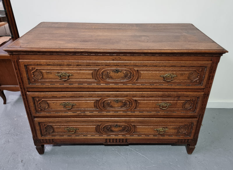 Early 19th Century French Oak chest of three drawers. It has beautiful handles and carvings. It is in good original detailed condition.