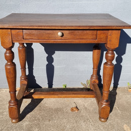 Rustic French Oak side table or desk with single drawer and turned legs. In good original detailed condition.