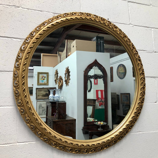 Decorative round gilt wall mirror.