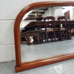 Art Deco mahogany mirror of long and narrow portions. In good original condition and retaining it's original mirror.
