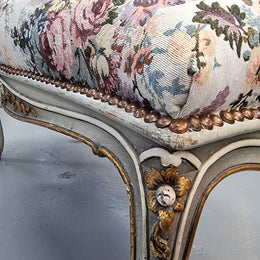 Antique painted Louis XV style upholstered stool. It has lovely floral upholstery that is in good condition with no tears. It is in good original detailed condition.