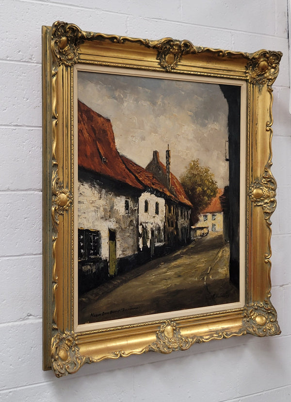 Dutch signed oil on canvas depicting village street in a beautiful gilt frame. It is in good original detailed condition and has been sourced from France.