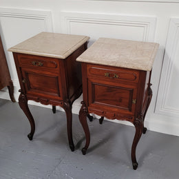 Pair of French Antiloopque Louis XV style Walnut and marble top bedsides. They have lovely carvings along with a drawer and cupboard space. They are in good original detailed condition and have been sourced from France