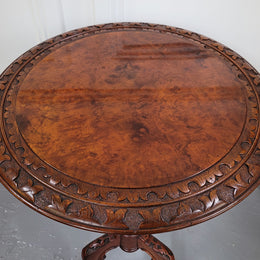 Rare early Victorian Irish Burr Walnut wine table. It has a beautiful carvings and a stunning burr walnut top, on a barley twist column and three shaped legs. It has been sourced locally and is in good original detailed condition. We also have a second table being sold separately which when together make a matched pair.