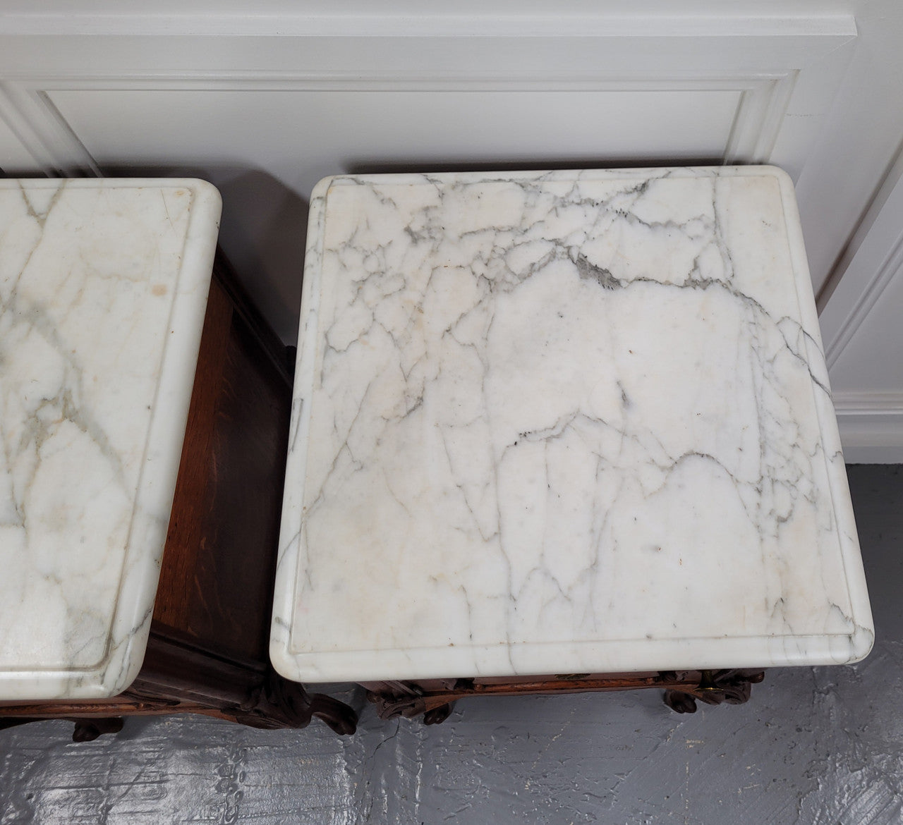 Pair of French Antique Louis XV style Oak marble top night stands. They have beautiful carved cabriole legs and beautiful white marble along with a drawer and cupboard for storage space. They have been sourced from France and are in good original detailed condition.