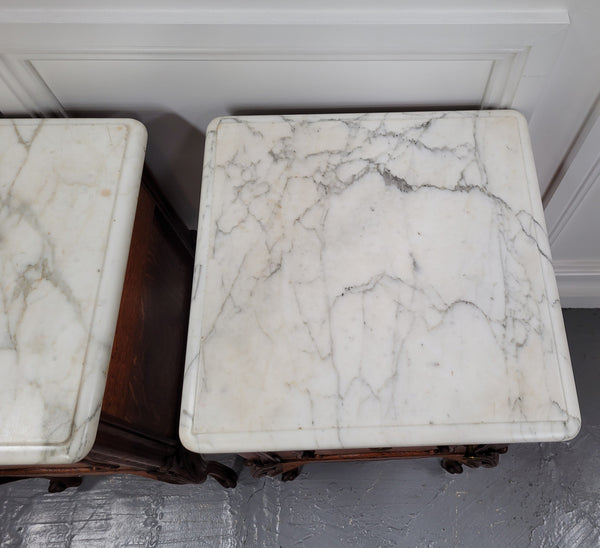Pair of French Antique Louis XV style Oak marble top night stands. They have beautiful carved cabriole legs and beautiful white marble along with a drawer and cupboard for storage space. They have been sourced from France and are in good original detailed condition.