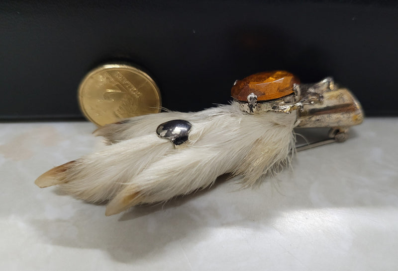 Scottish Grouse foot with Amber coloured glass. In good original condition, please view photos as they help form part of the description.