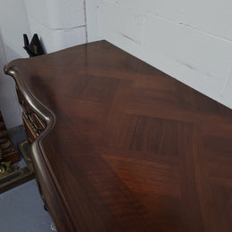 Fabulous Louis XV style French Walnut and Burr Walnut four door sideboard. Each door panel has beautiful Burr Walnut panels and open up to an adjustable shelf. Beautiful handles and two drawers for added storage. In good original detailed condition.