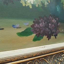 An Antique framed floral painting of lilacs in a vase on canvas, signed and in fantastic original condition.