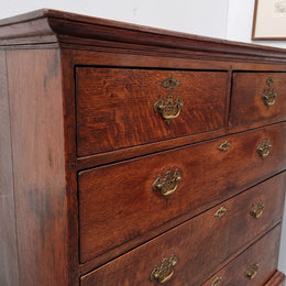 Early 19th Century English Oak chest on stand. It has been sourced in France and has plenty of storage space with eight drawers. In good original detailed condition.