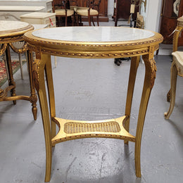 Impressive French oval Louis XVI style gilt and white marble topped two tier lamp/side table. It has been sourced from France and is in good original detailed condition.