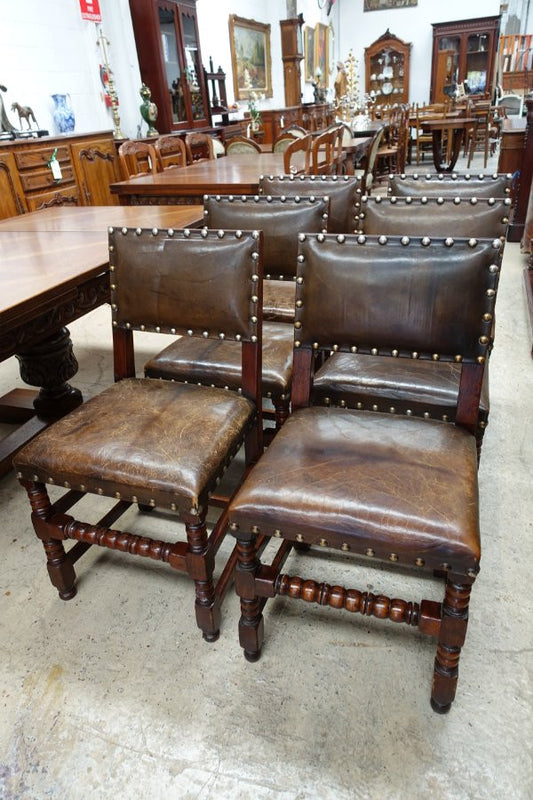 Here we have a fabulous set of six French oak rustic leather dining chairs with two carvers. Chairs are upholstered in brown leather and are very comfortable and solid. Is in very good original condition.