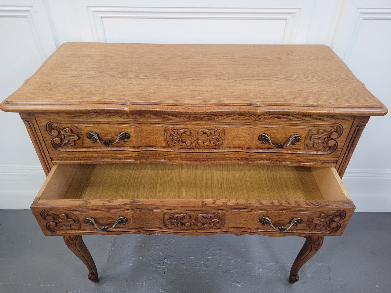 French Oak Louis 15th style nicely carved three drawer wooden top commode. It has been sourced from France and is in good original detailed condition.