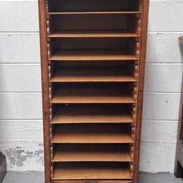 Antique Edwardian roll top Tambour file cabinet desk. This practical antique tambour front filing cabinet dates around 1900 in the Edwardian period and is constructed from Oak. This antique cabinet has an adjustable writing slope, above a tambour front with key and working lock. It has been sourced locally and is in good original detailed condition.