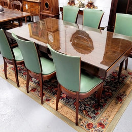 French Art Deco Figured Walnut dining table and six chairs. This stylish table also comes with a glass top and can be used with or without it. The chairs are very comfortable and the table can also fit another two chairs at either end making it a 6-8 seater. The table is in good original detailed condition with character marks to the top of table as shown in the pictures. This table and six chairs have been sourced locally.