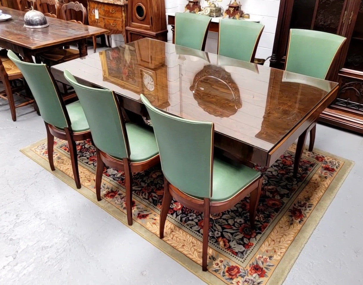 French Art Deco Figured Walnut dining table and six chairs. This stylish table also comes with a glass top and can be used with or without it. The chairs are very comfortable and the table can also fit another two chairs at either end making it a 6-8 seater. The table is in good original detailed condition with character marks to the top of table as shown in the pictures. This table and six chairs have been sourced locally.