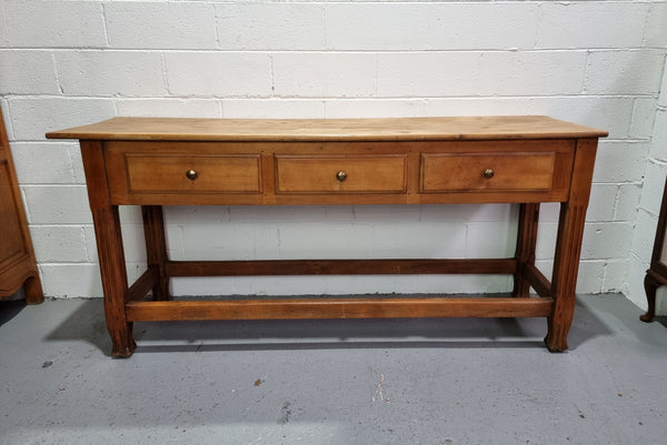 Late 19th Century Cherrywood console table with three drawers. In good used, detailed rustic condition.