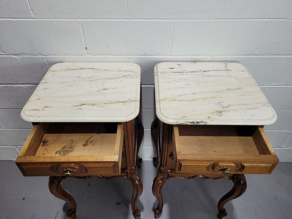 Pair of Louis XV style bedside cabinets with beautiful marble tops and one drawer and single cupboard for all your storage needs. In good original detailed condition.