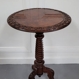 Rare early Victorian Irish Burr Walnut wine table. It has a beautiful carvings and a stunning burr walnut top, on a barley twist column and three shaped legs. It has been sourced locally and is in good original detailed condition. We also have a second table being sold separately which when together make a matched pair.