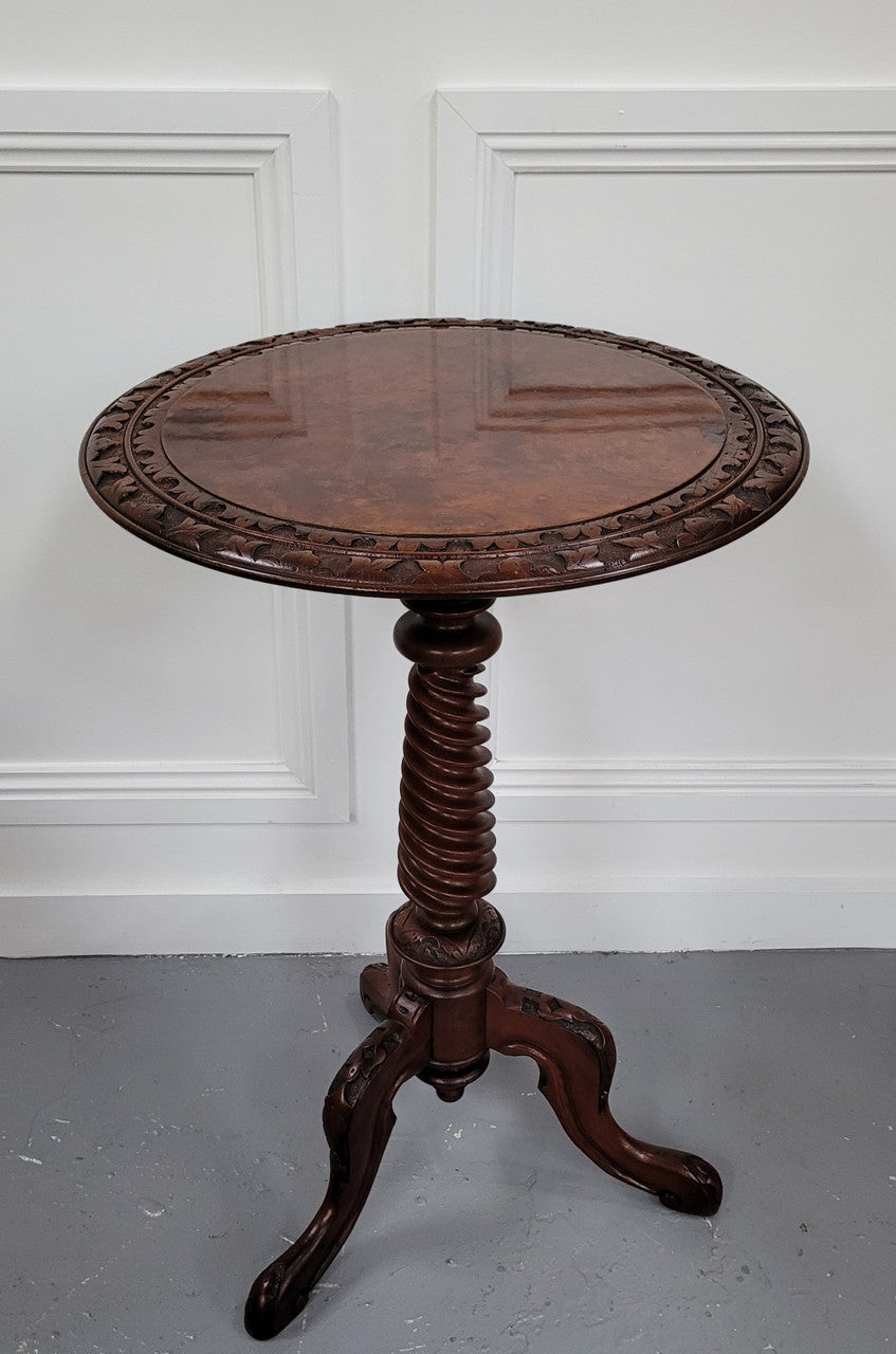Rare early Victorian Irish Burr Walnut wine table. It has a beautiful carvings and a stunning burr walnut top, on a barley twist column and three shaped legs. It has been sourced locally and is in good original detailed condition. We also have a second table being sold separately which when together make a matched pair.