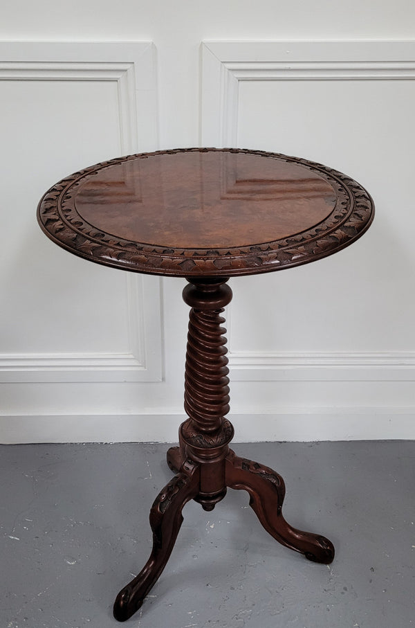Rare early Victorian Irish Burr Walnut wine table. It has a beautiful carvings and a stunning burr walnut top, on a barley twist column and three shaped legs. It has been sourced locally and is in good original detailed condition. We also have a second table being sold separately which when together make a matched pair.