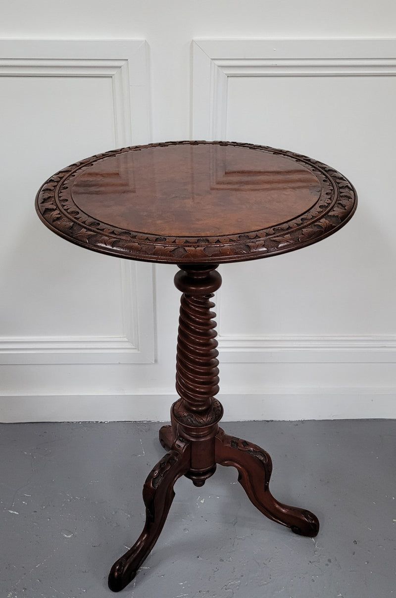 Rare early Victorian Irish Burr Walnut wine table. It has a beautiful carvings and a stunning burr walnut top, on a barley twist column and three shaped legs. It has been sourced locally and is in good original detailed condition. We also have a second table being sold separately which when together make a matched pair.