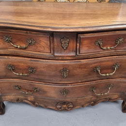 Impressive French Louis XV style Cherrywood four drawer commode, with a wooden top, two large drawers and two smaller drawers. Features attractive handles and a carved skirt and feet. In good original detailed condition.